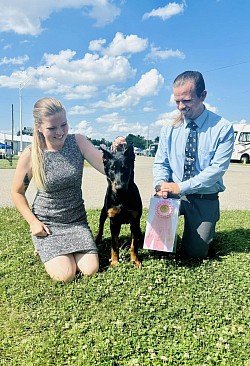 EV Valkyrie At Irukandji de la Fleur De Renard “Valkyrie” and two of her Co-Owners with Valkyrie's AKC Beginner Puppy Herding Group One!